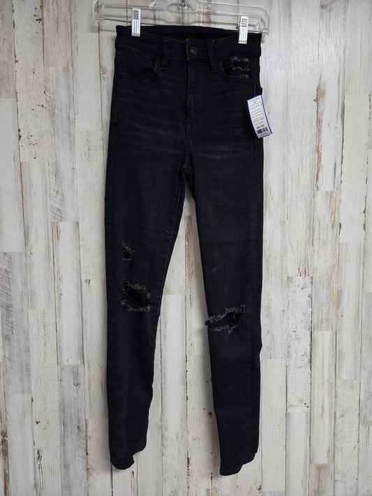 BLACK AMERICAN EAGLE 000 DISTRESSED SKINNIES, LADIES XS