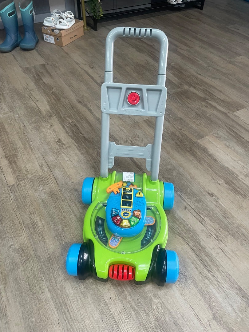 GREEN VTECH PUSH LAWN MOWER- NEEDS BATTERIES